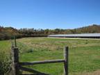 326078-53 acre farm w/ 70,000sq ft under roof, creek,& paved rd front.