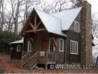 Custom Built Home with Several Texures of Wood for Cottage Look.