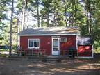 Quiet cabin in the woods of Brownfield with amenities. Located on Peqwaket Pond