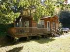 Just Reduced! Adorable wood-sided cabin on lot with room to expand.