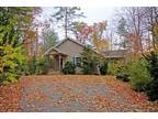 Private wooded setting with beautiful conifers and deciduous specimens surroundi