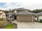 Backing Onto Bow River and Walking Path Fully Devoloped Walkout Home $