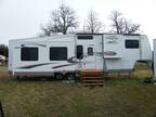 2005 Prowler Regal 36ft F/W Tvl Tlr w/4 tip outs & 2 gas fireplaces