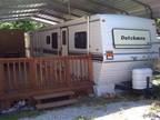 1996 Dutchmen 36' with slide on lot with deck