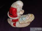 Kneeling Santa Praying over Baby Jesus