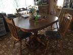 Offered: pedestal oak table and four chairs,