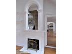 White Fireplace Mantel With Beautiful Arched Mirror