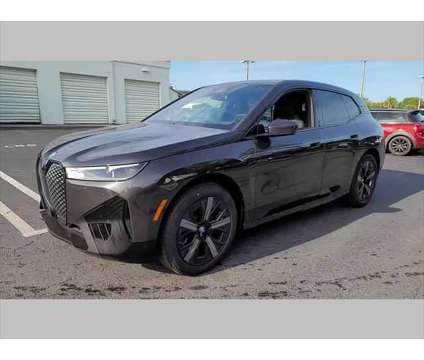 2024 BMW iX xDrive50 is a Grey 2024 BMW 325 Model iX SUV in Jacksonville FL