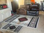 One leather arm chair, one recliner, 2 area rugs