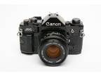 Canon A-1 35mm SLR w/50mm F1.8 lens, grip, strap, new seals, tested, great!