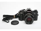 Canon A-1 35mm SLR w/50mm F1.8 S.C. lens, grip, strap, new seals, tested, good!