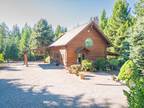 Custom-built log home, situated on an expansive 46-acre estate.