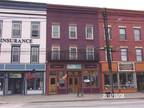 Owego, - River Row mixed use building. Store front and 2