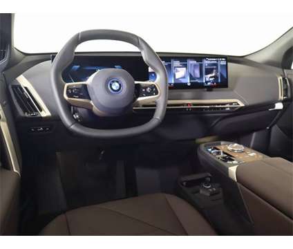 2024 BMW iX xDrive50 Sales Demo is a Red 2024 BMW 325 Model iX SUV in Edmond OK
