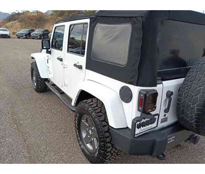 2013 Jeep Wrangler Unlimited Freedom Edition is a White 2013 Jeep Wrangler Unlimited SUV in Cottonwood AZ