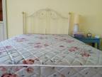 Double bed with iron headboard - used; includes mattresses