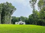 Recently completed modern simplistic home facing north on 11 wooded acres.