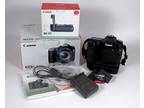 Canon EOS 50D Camera with battery grip, two batteries, and memory card