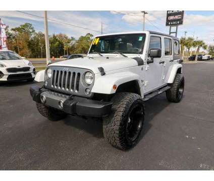 2014 Jeep Wrangler Unlimited Freedom Edition is a White 2014 Jeep Wrangler Unlimited Car for Sale in Homosassa FL