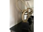art deco piece Golden knot on a black pedestal. 29 inches tall.