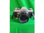 Canon AE-1 Program 35mm Manual SLR Film Camera with 50mm 1:1.8 Lens.