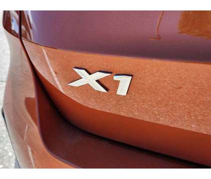 2024 BMW X1 xDrive28i is a Orange 2024 BMW X1 xDrive 28i SUV in Loveland CO