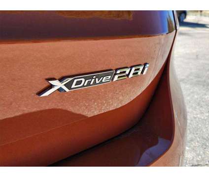 2024 BMW X1 xDrive28i is a Orange 2024 BMW X1 xDrive 28i SUV in Loveland CO