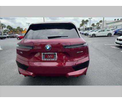 2024 BMW iX xDrive50 is a Red 2024 BMW 325 Model iX SUV in Jacksonville FL