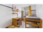 Bed in a bright twin bedroom, in Carnegie Hill