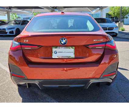 2024 BMW i4 xDrive40 is a Orange 2024 Sedan in Loveland CO