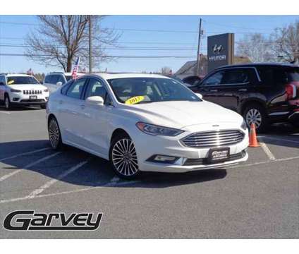 2017 Ford Fusion SE is a Silver, White 2017 Ford Fusion SE Sedan in Plattsburgh NY