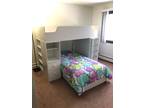 White twin loft bed with storage area and work station
