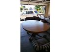 Solid Oak Dining Room table with six chairs - two are captain