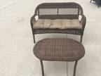 Light brown rattan loveseat with table