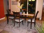 Dining Table with 4 chairs with white padded seats.