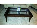 Beautiful matching coffee tables dark wood with glass cutouts.