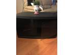 Black tv stand. 35 inches wide 18 inches high glass doors and shelf inside