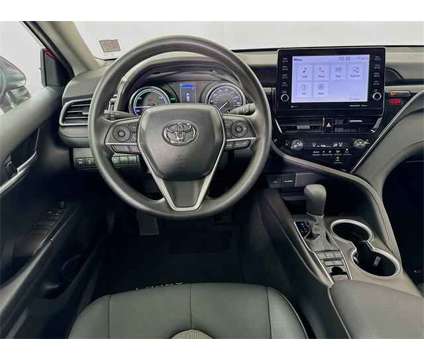 2023 Toyota Camry LE Hybrid is a Red 2023 Toyota Camry LE Hybrid in Saint Augustine FL