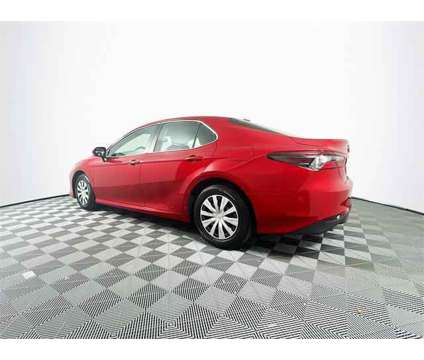 2023 Toyota Camry LE Hybrid is a Red 2023 Toyota Camry LE Hybrid in Saint Augustine FL
