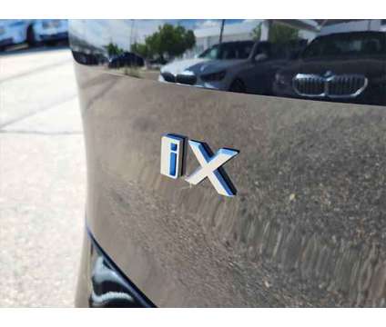 2025 BMW iX xDrive50 is a Black 2025 BMW 325 Model iX SUV in Loveland CO