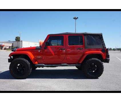 2015 Jeep Wrangler Unlimited Sahara is a Red 2015 Jeep Wrangler Unlimited Sahara SUV in Tampa FL