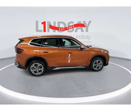 2023 BMW X1 xDrive28i is a Orange 2023 BMW X1 xDrive 28i SUV in Manassas VA