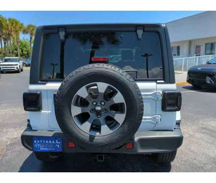 2018 Jeep Wrangler Unlimited Sahara is a White 2018 Jeep Wrangler Unlimited Sahara SUV in Daytona Beach FL