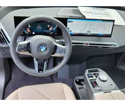 2025 BMW iX xDrive50 is a Red 2025 BMW 325 Model iX SUV in Loveland CO