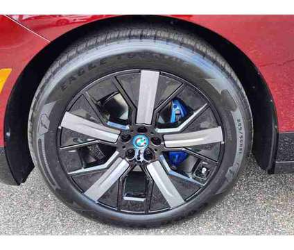 2025 BMW iX xDrive50 is a Red 2025 BMW 325 Model iX SUV in Loveland CO