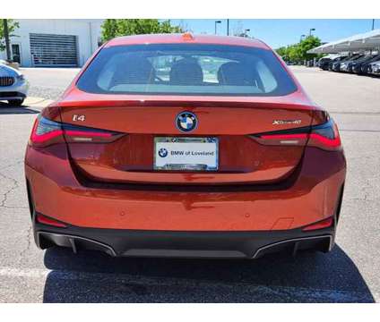 2024 BMW i4 xDrive40 is a Orange 2024 Sedan in Loveland CO