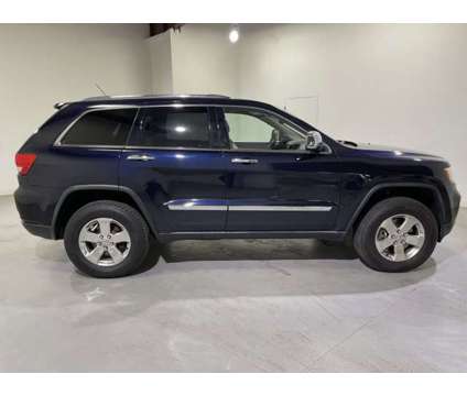 2011 Jeep Grand Cherokee Overland is a White 2011 Jeep grand cherokee Car for Sale in Traverse City MI