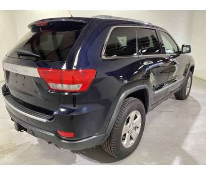 2011 Jeep Grand Cherokee Overland is a White 2011 Jeep grand cherokee Overland Car for Sale in Traverse City MI