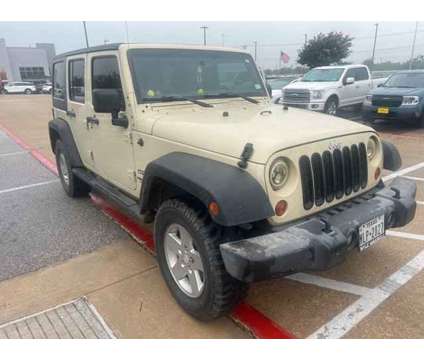 2011 Jeep Wrangler Unlimited Sport is a Tan 2011 Jeep Wrangler Unlimited Sport Car for Sale in Georgetown TX