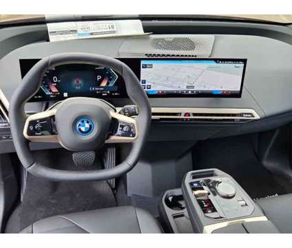 2025 BMW iX xDrive50 is a Red 2025 BMW 325 Model iX SUV in Loveland CO